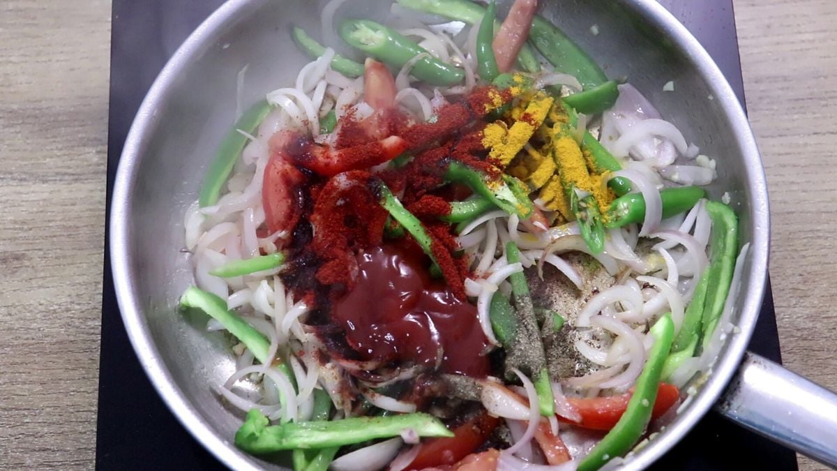 Spices and sauces added for squid chilli fry.