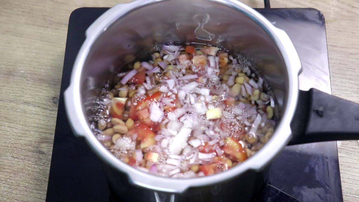 Cooking soaked alsane in a pressure cooker.