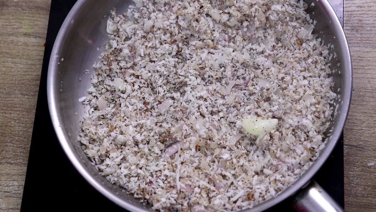 Roasting grated coconut until golden.