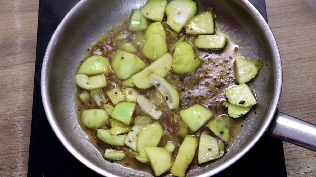 addition of raw mangoes and a little water to cook them.