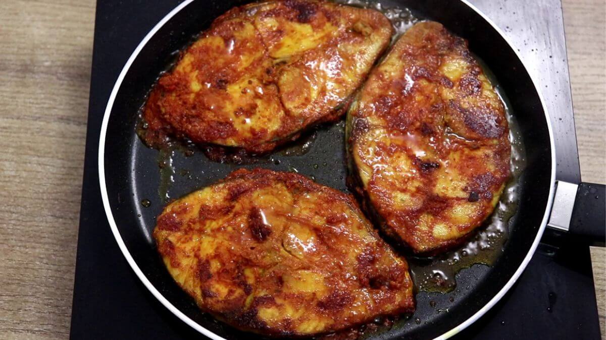 frying marinated fish on tawa.