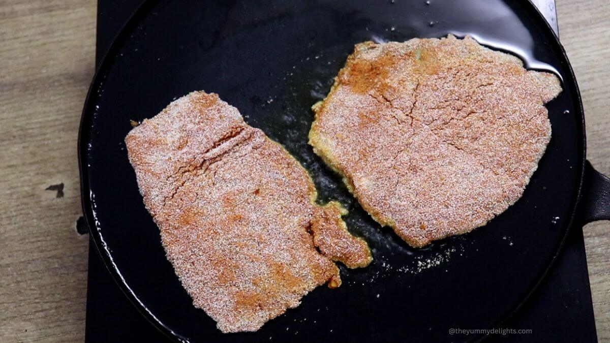 Shallow frying chonak fish in pan until crispy.
