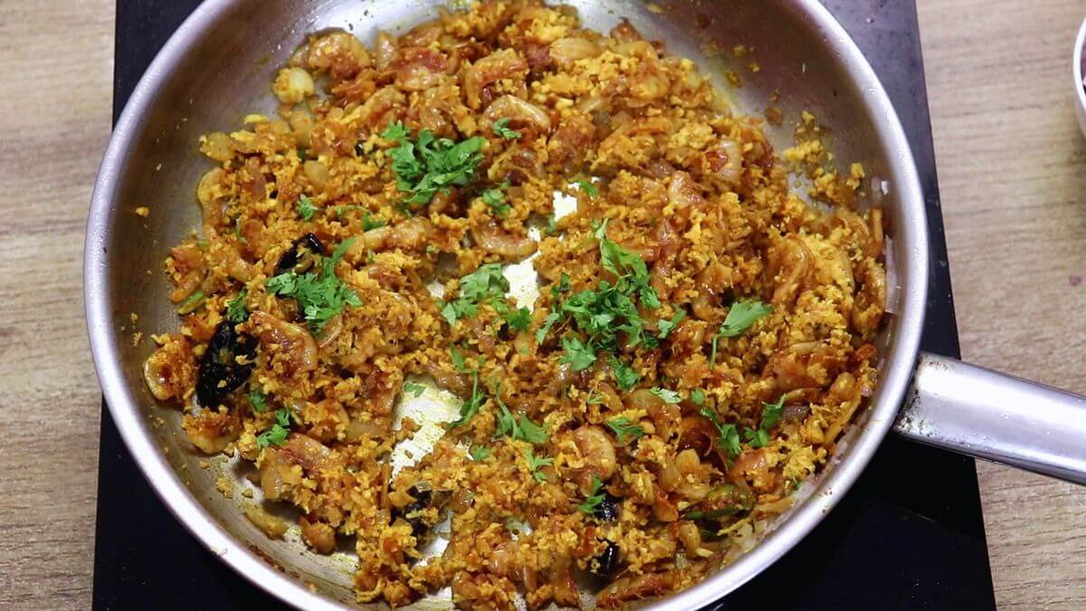 garnishing prawns kismoor with coriander leaves.