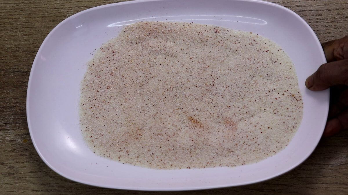 Preparing rava mixture for fish fry.