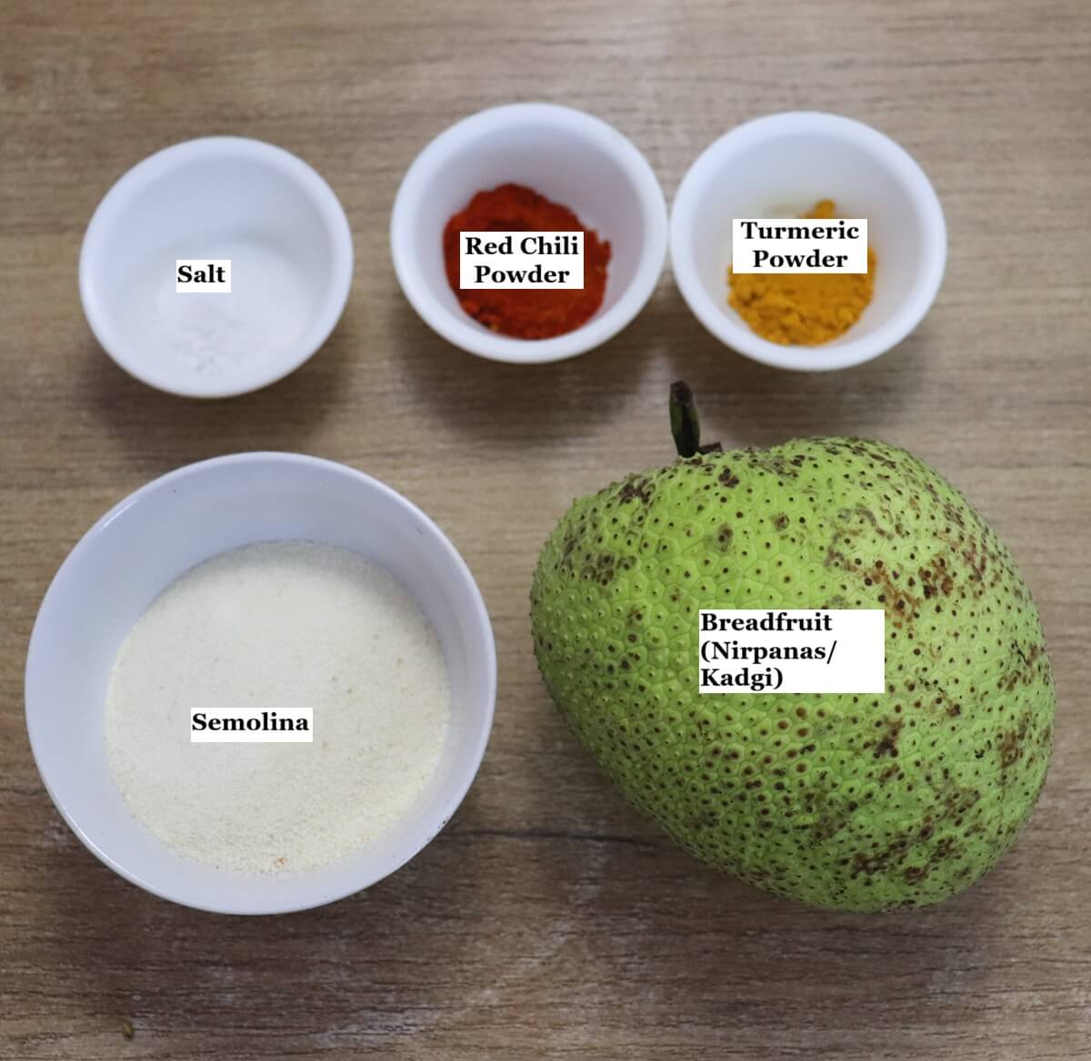 individually labelled ingredients to make breadfruit fry or nirpanas fry are laid out on a table.