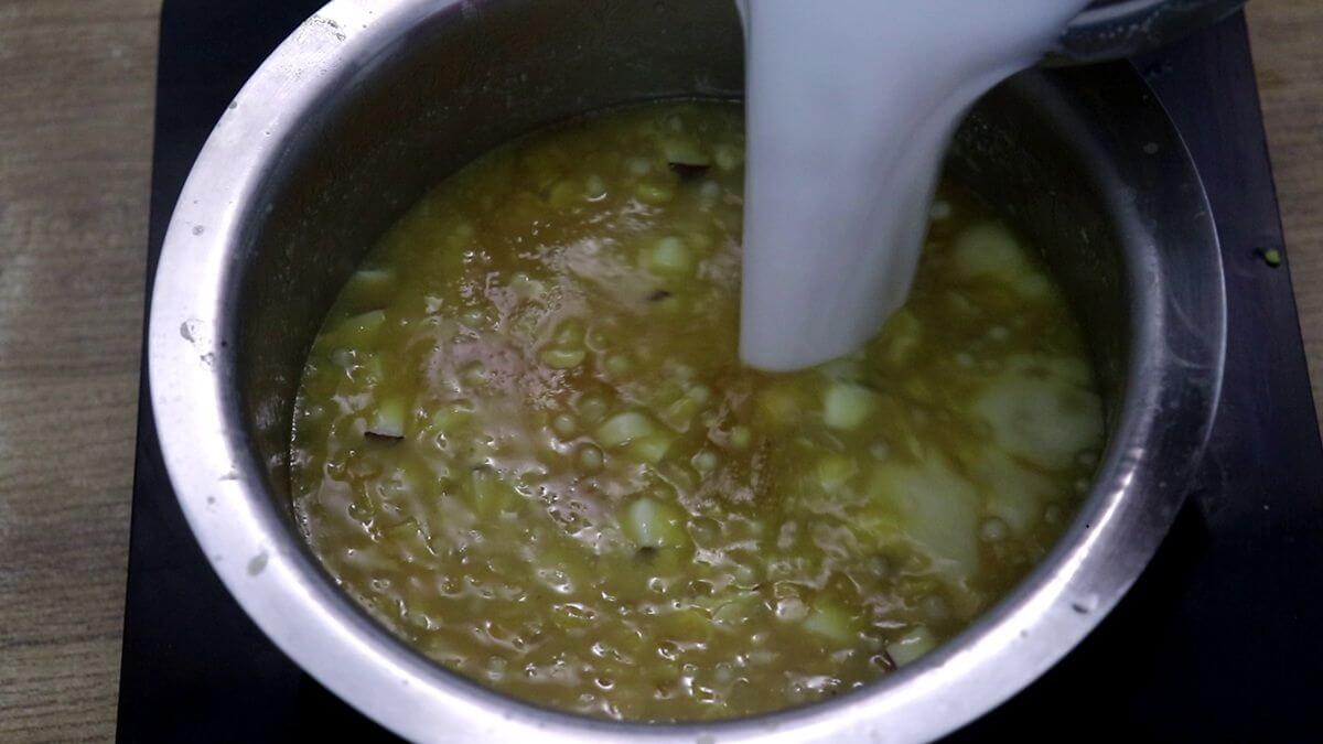 Addition of coconut milk to make mangane.
