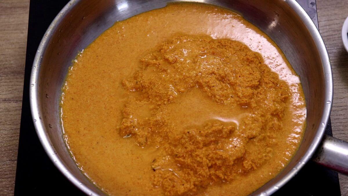 Heating the ground coconut masala in a pan to make fish sukka.