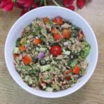 Mediterranean tuna salad served in white bowl garnished with dill leaves.