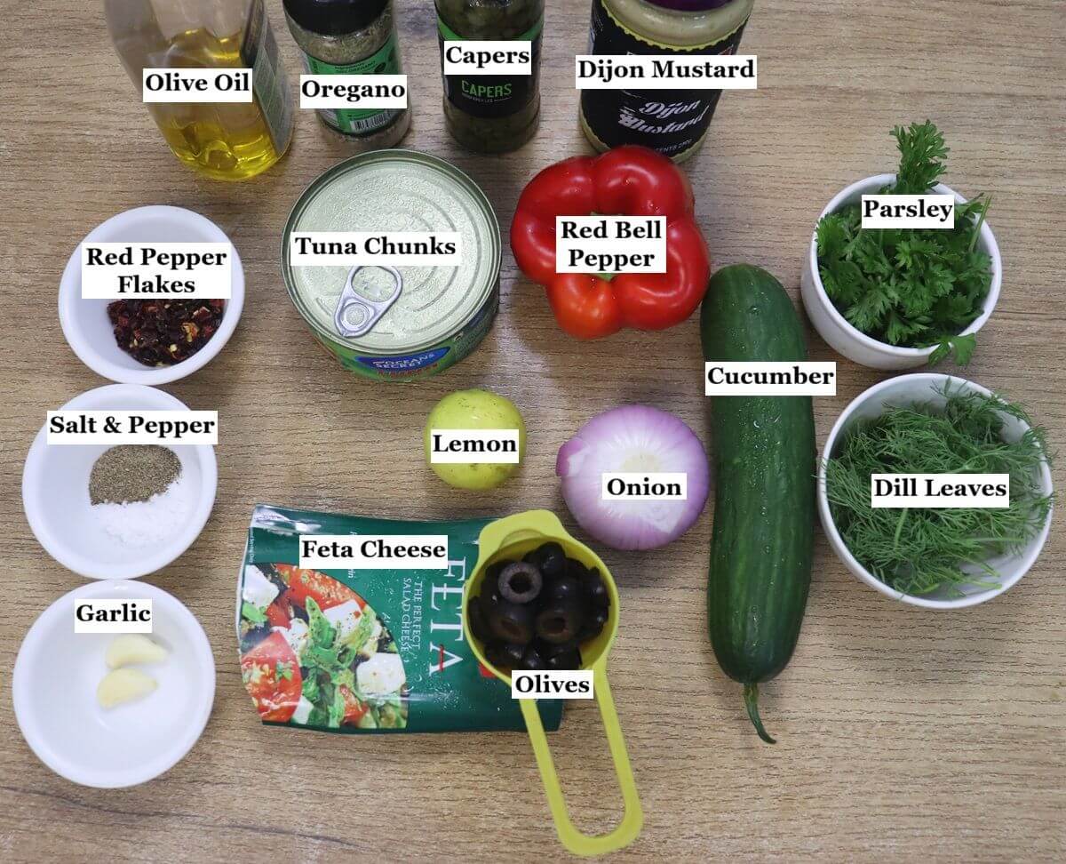 individually labelled ingredients to make mediterranean tuna salad are laid out on a table.