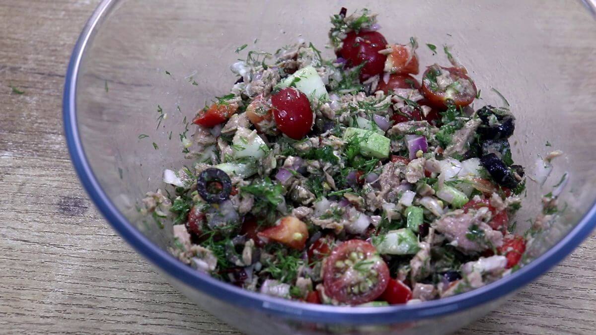 Mediterranean tuna salad in a glass bowl.