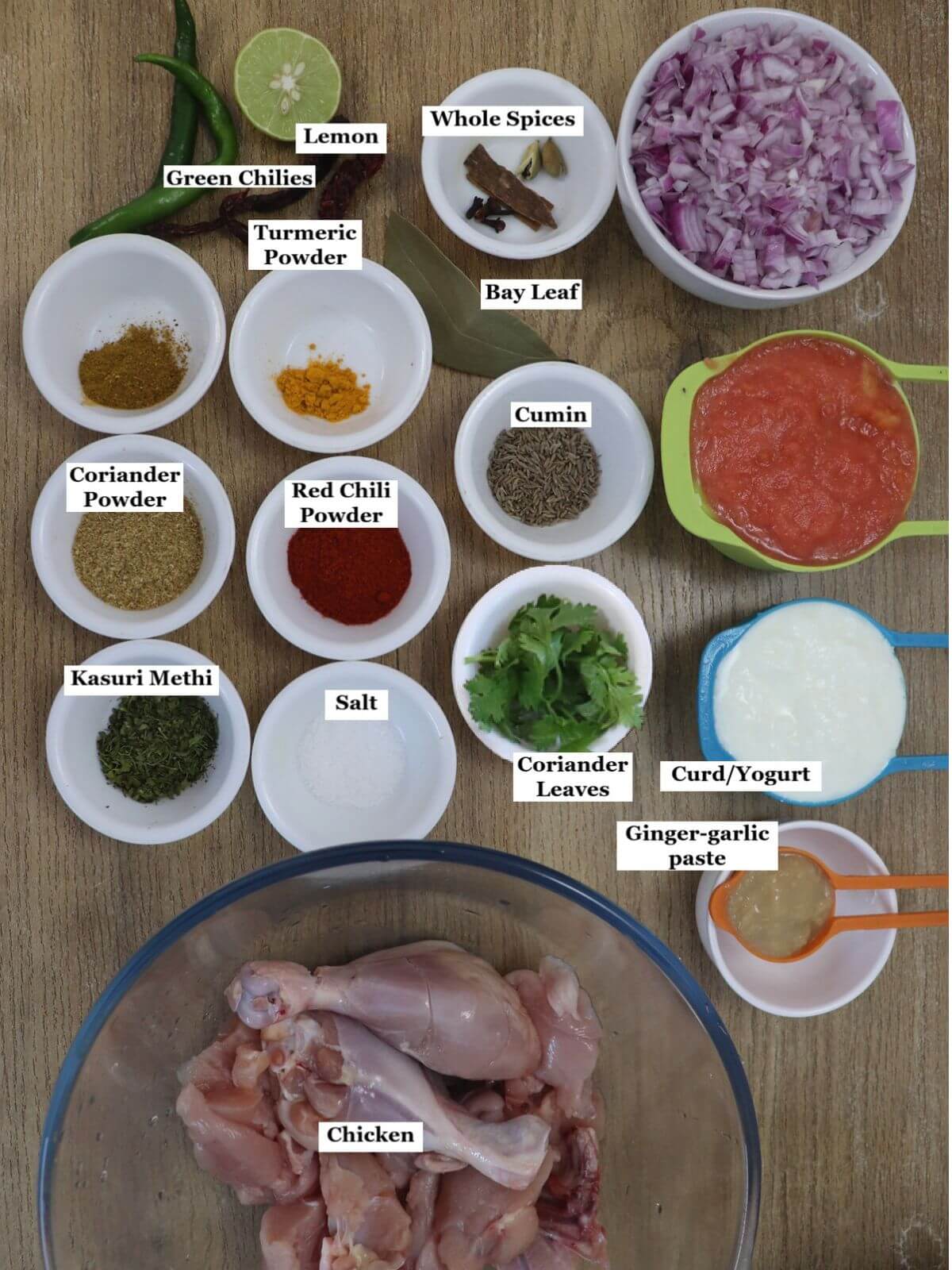 individually labelled ingredients to make pressure cooker chicken curry are laid out on a table.