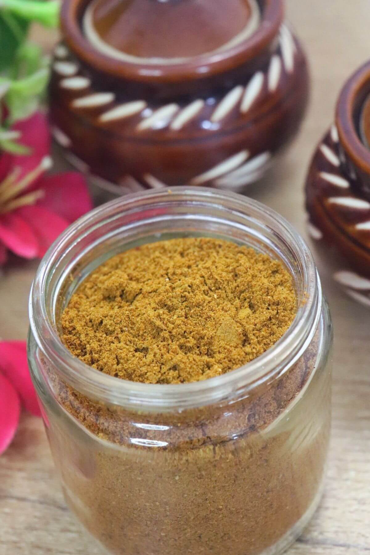 Homemade Goan Xacuti masala powder in a glass jar.