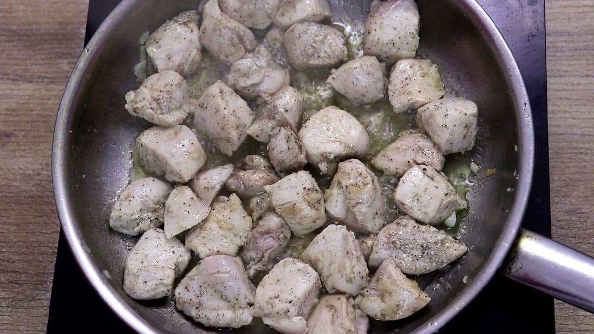 Marinated chicken breast cooking in a skillet for Mediterranean lemon garlic chicken.