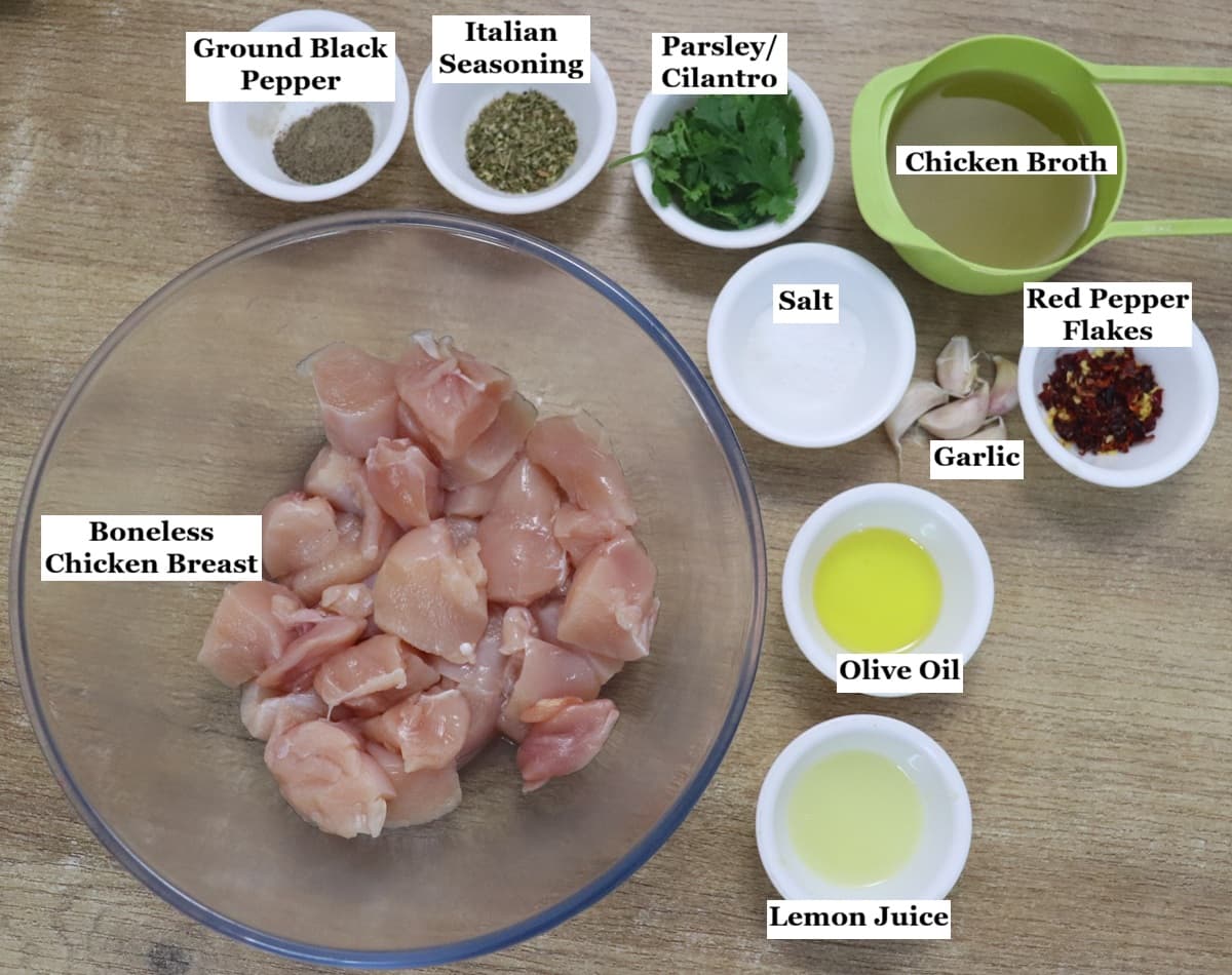 individually labelled ingredients to make lemon garlic chicken are laid out on a table.