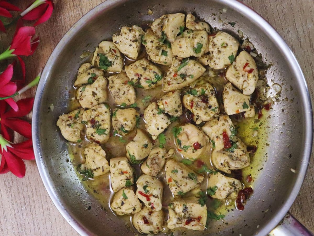 lemon garlic chicken in a pan with lemon garlic sauce.