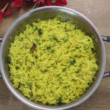 Mediterranean yellow rice in a pot. Garnished with cilantro.
