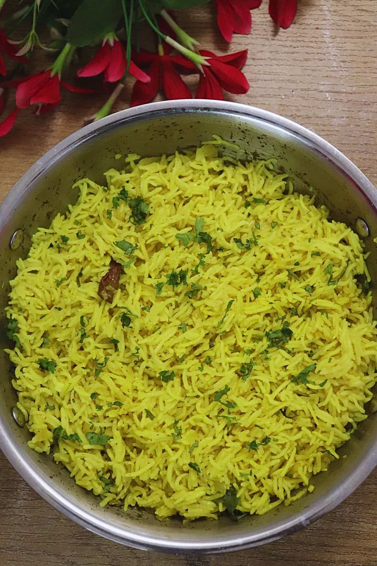 Fluffy Mediterranean yellow rice with turmeric in a cooking pot.