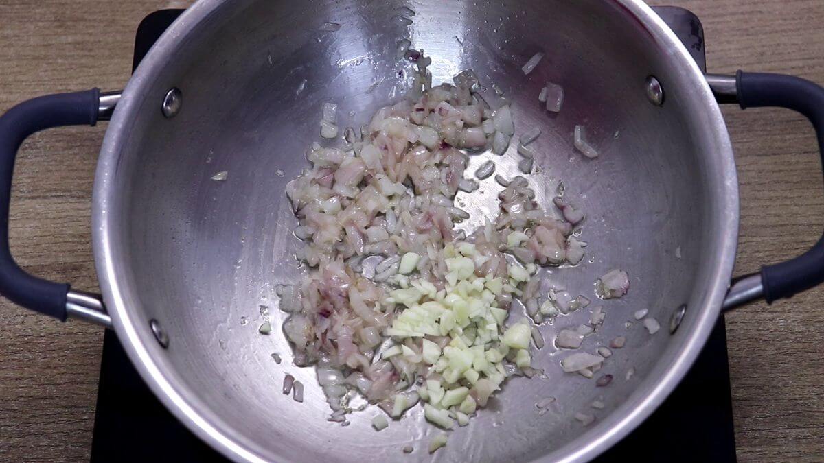 sauteing onion and garlic to make yellow rice.