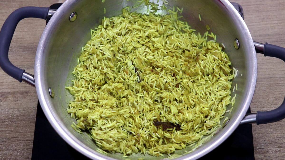 toasting the rice in turmeric and spices.