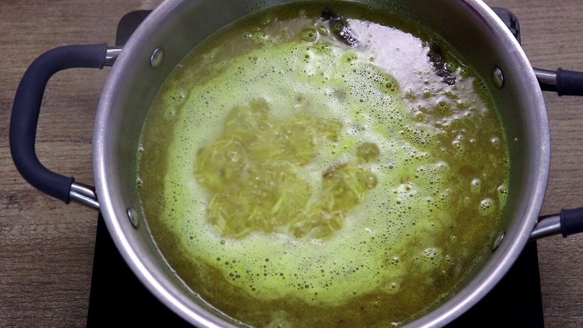 addition of homemade chicken broth to the pot to cook yellow rice.