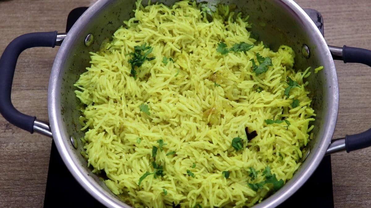 Garnishing yellow rice with cilantro.