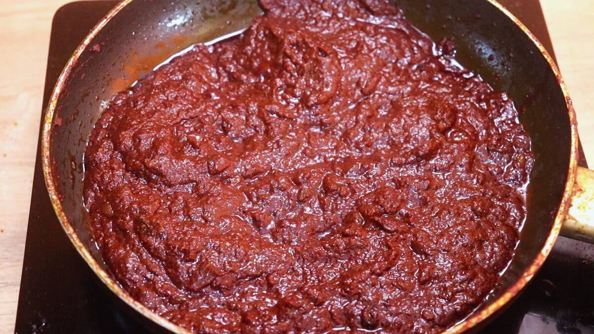 Ghee roast masala cooking until the ghee separates from the sides of the pan.
