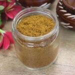 Xacuti masala stored in a glass jar.