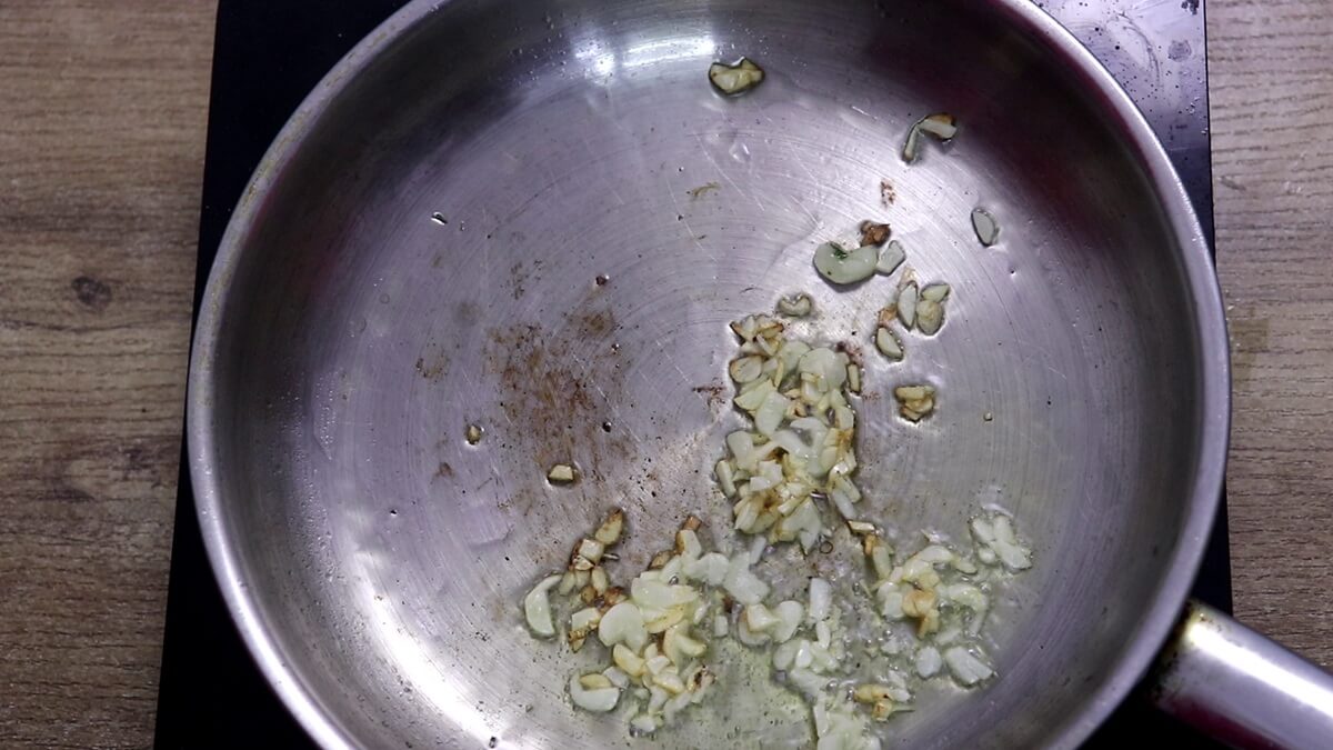 Garlic sautéing in olive oil for lemon garlic broccoli.