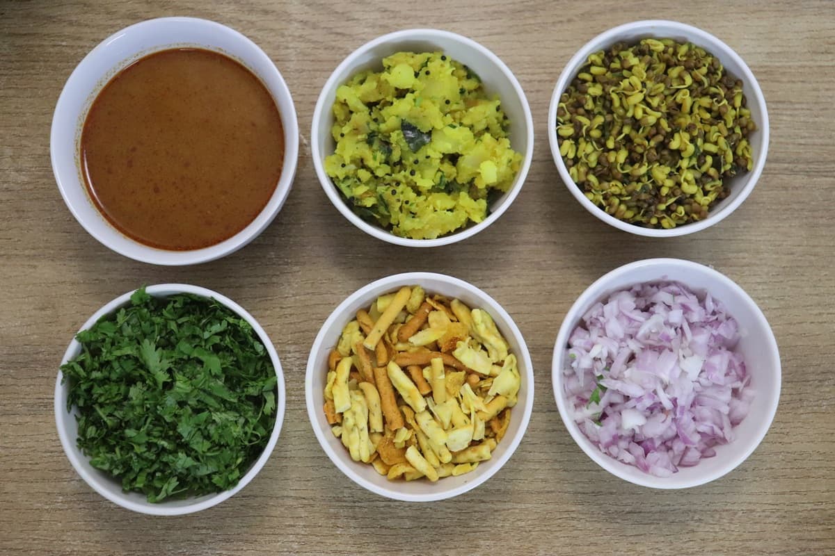 Kolhapuri Misal Pav toppings - farsan, onions, coriander, matki sprouts, batata bhaji, and tarri.