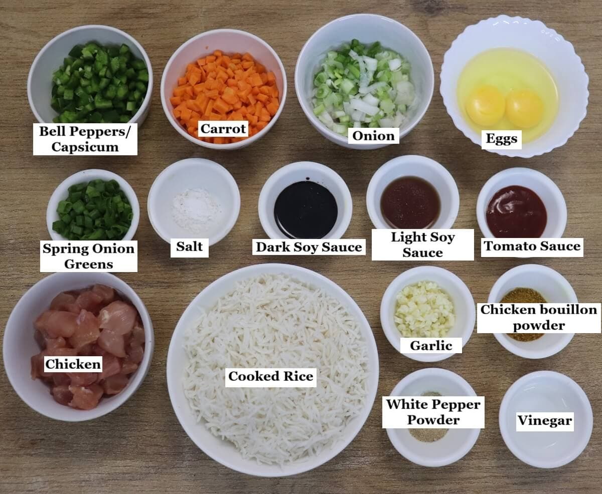 individually labelled ingredients to make chicken fried rice restaurant style recipe are laid out on a table.