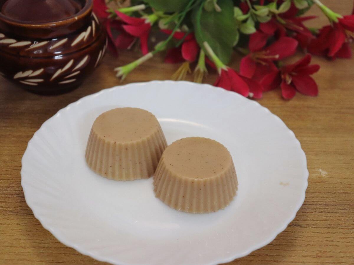 ragi pudding (finger millet pudding) served in a white plate.