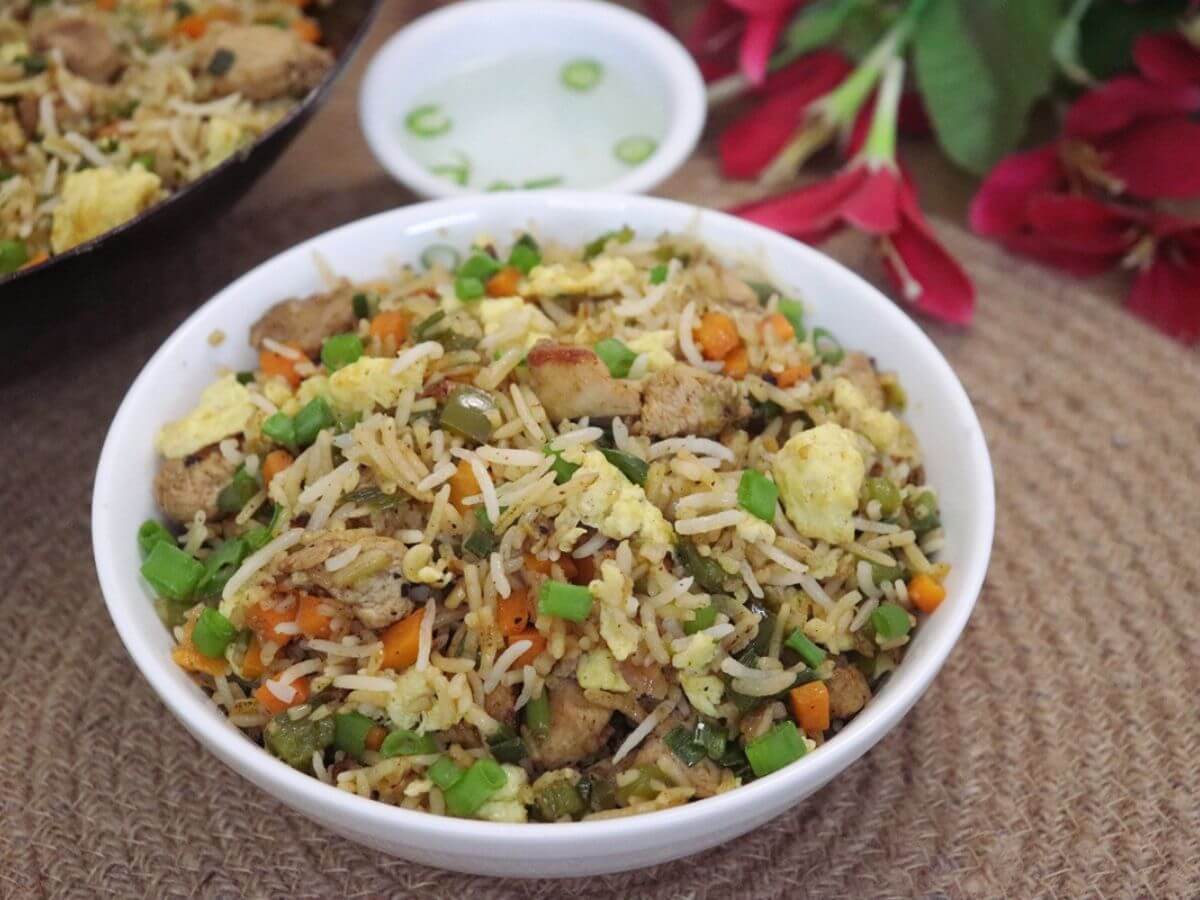 Restaurant-style chicken fried rice with vegetables and eggs.