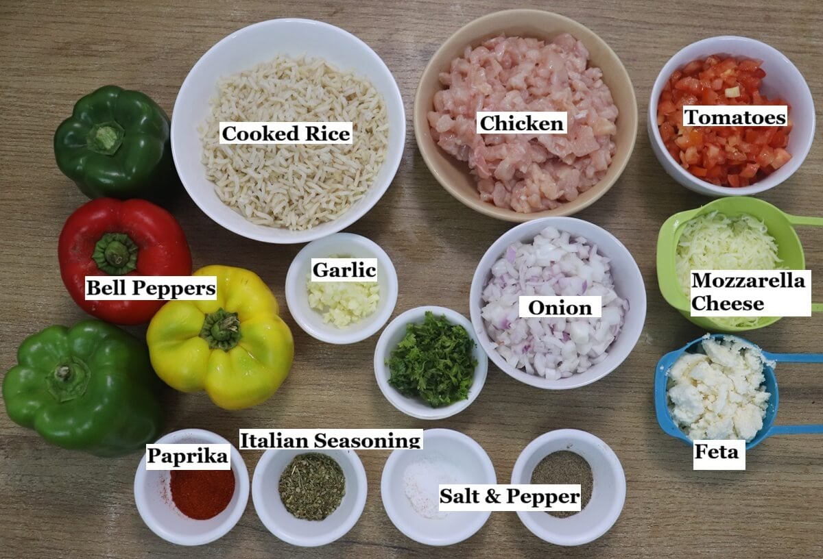 individually labelled ingredients to make Mediterranean stuffed peppers are laid out on a table.
