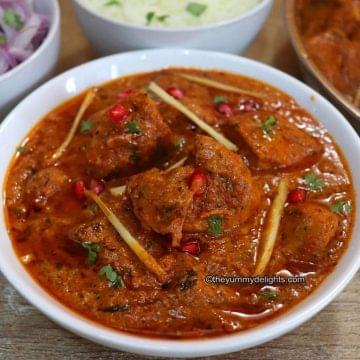 close-up of dishoom's chicken ruby curry served in a white bowl.
